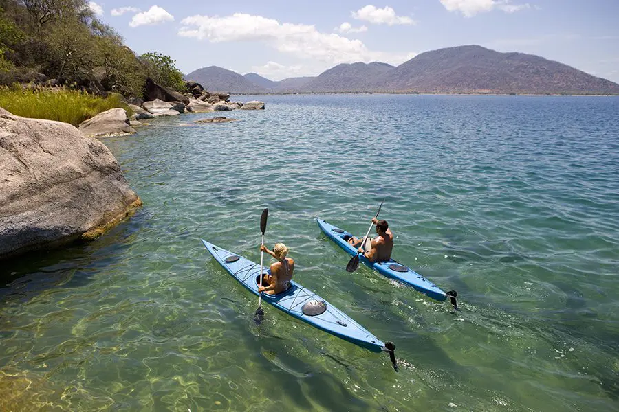 Couple canoeing in Lake Malawi of Mumbo Island, Malawi.